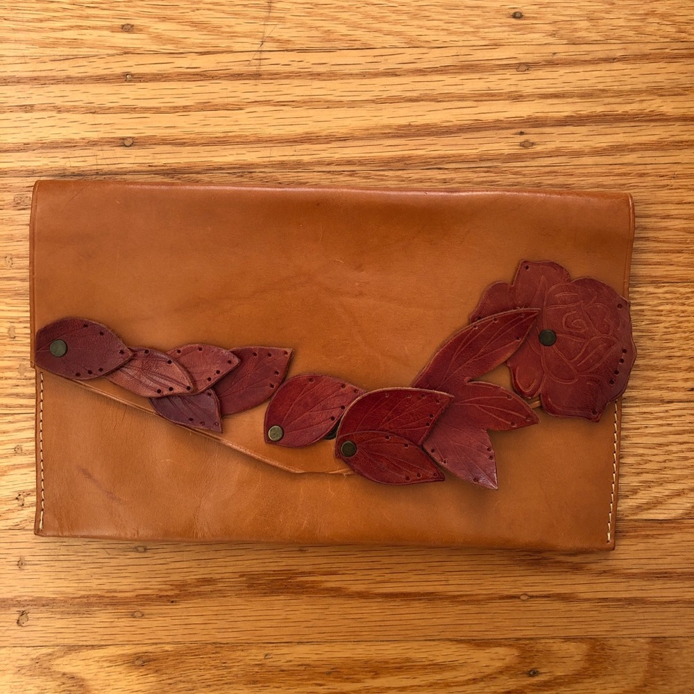 Leather clutch with leather cut out florals